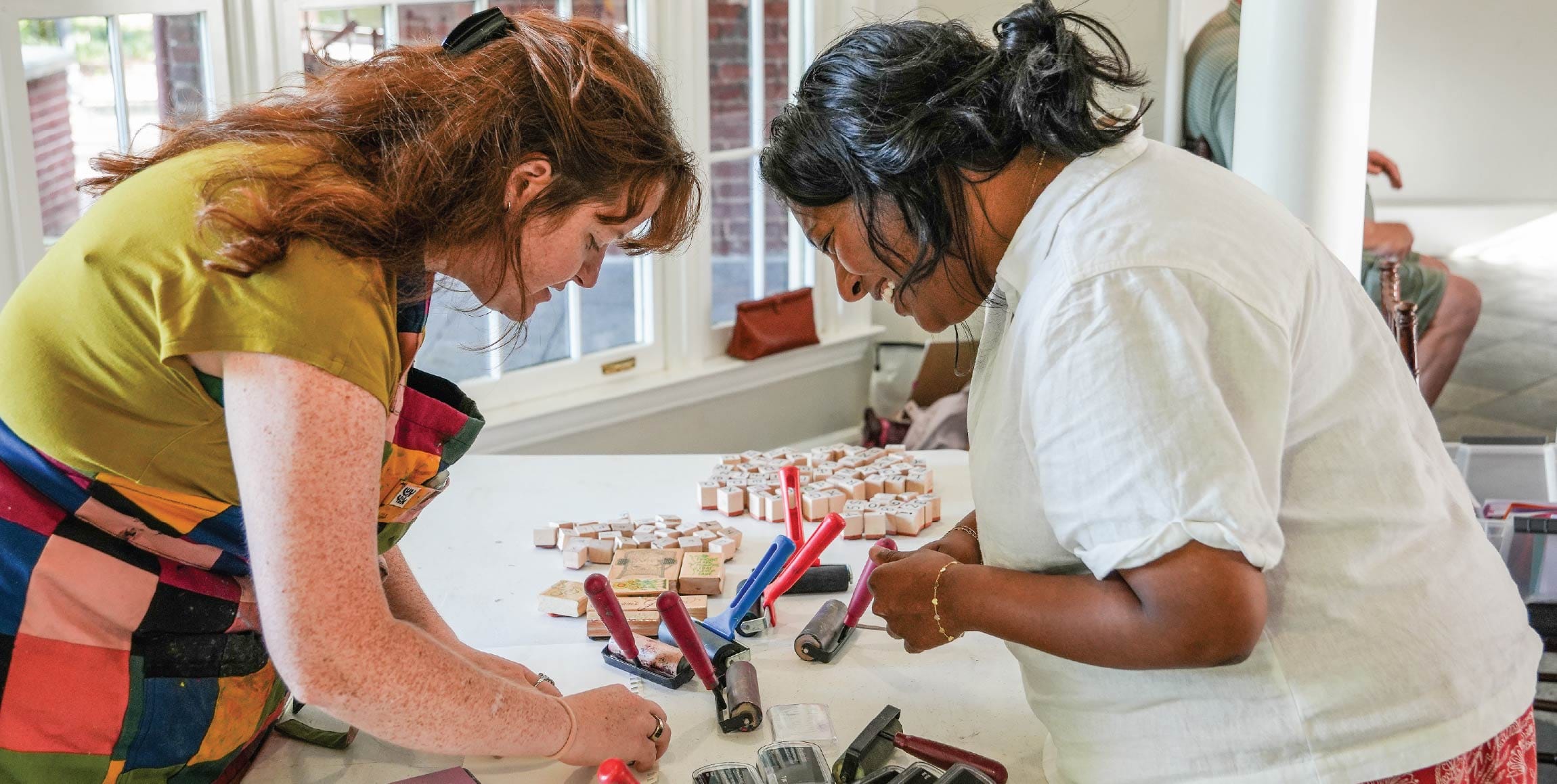 LocalArtists_Main Two participants working on block printing during a community art workshop