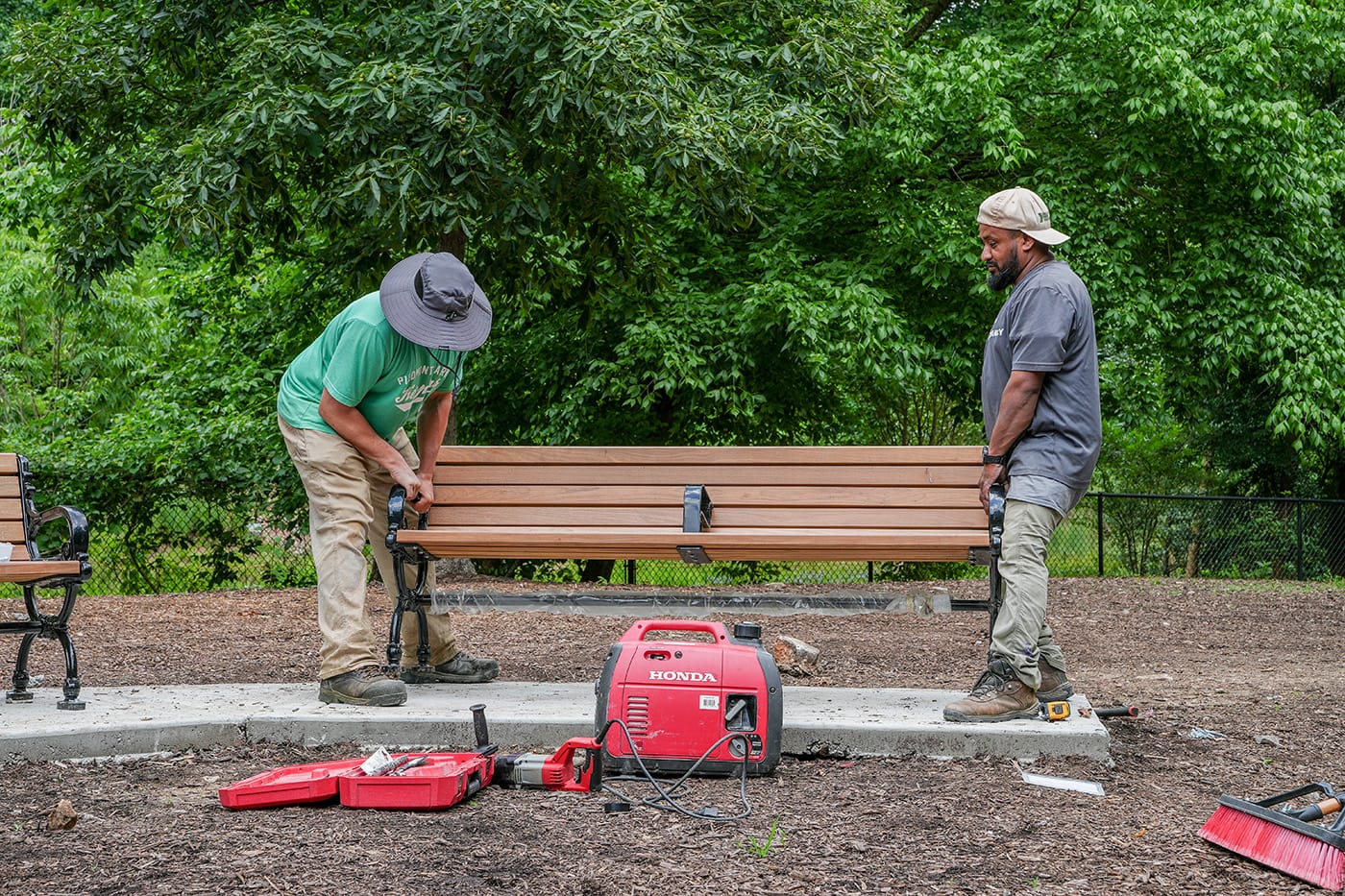 Dog Park Renovations-2026 3 Community workers installing a new bench during dog park renovations to create a welcoming space for dogs and residents.