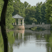 Community gathering at Piedmont Park overlooking Lake Clara Meer and the historic stone bridge